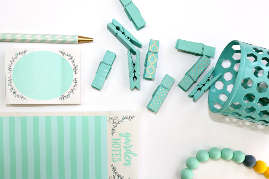 how to build habits that stick - teal planner, pencil, clothespins