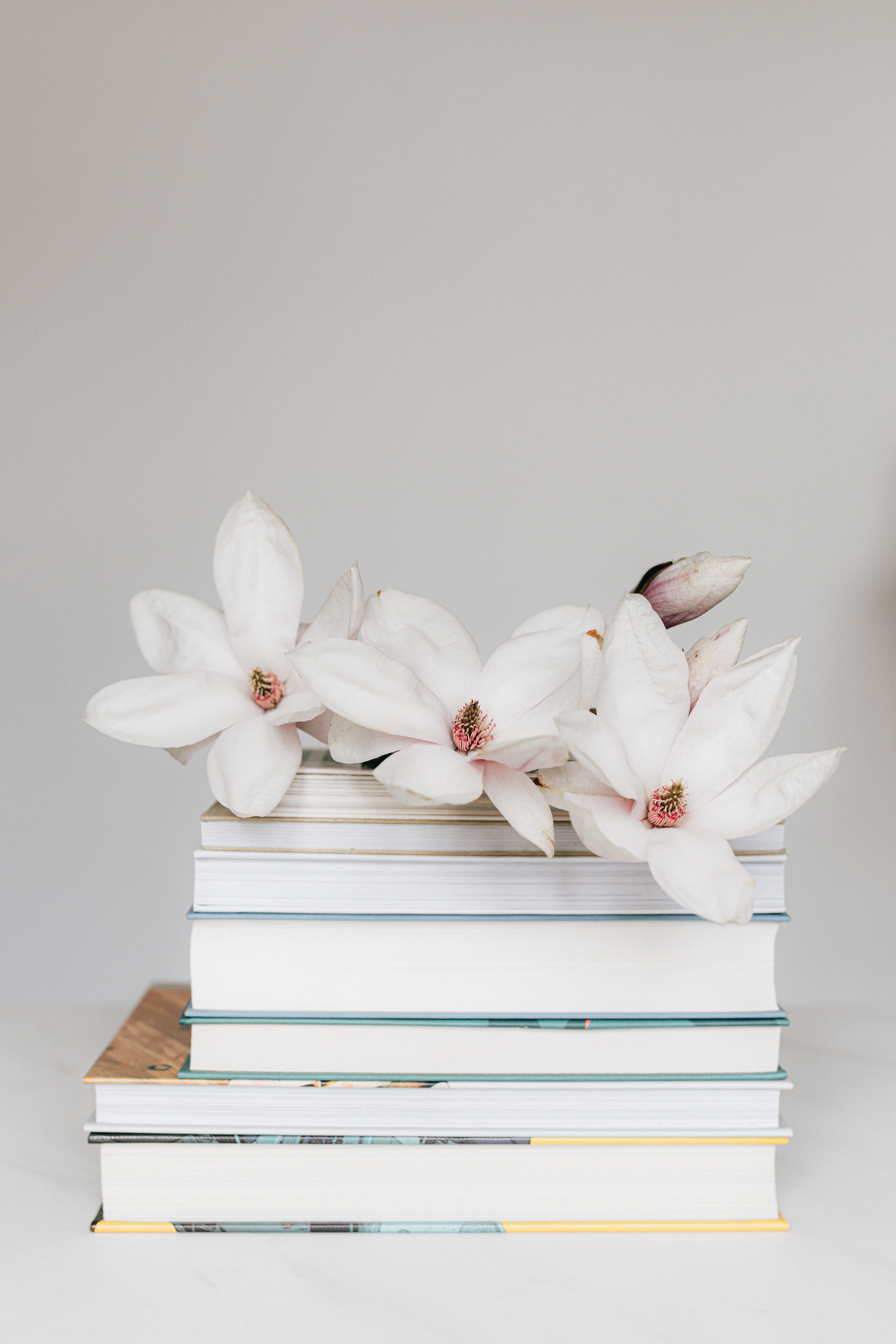 how to find your why as a mom - pretty flowers on top of a stack of books