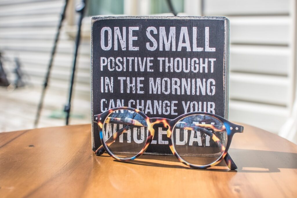 positive mindset - Photo of a Sign and Eyeglasses on Table